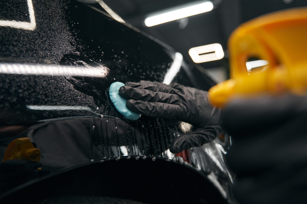 Auto detailing professional preparing automobile for polishing in San Diego mobile detailing service.